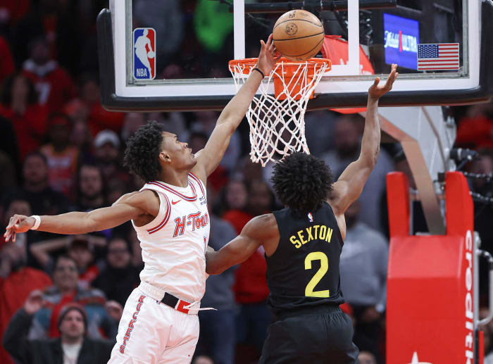 Rockets forward Amen Thompson (1) blocks a shot by Utah Jazz guard Collin Sexton (2) during overtime at Toyota Center.